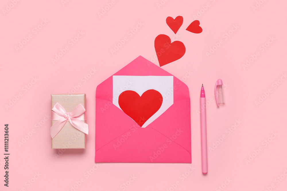 Composition with envelope, card, gift box and paper hearts for Valentine's Day celebration on pink background Composition with envelope, card, gift box and paper hearts for Valentine's Day celebration on pink background