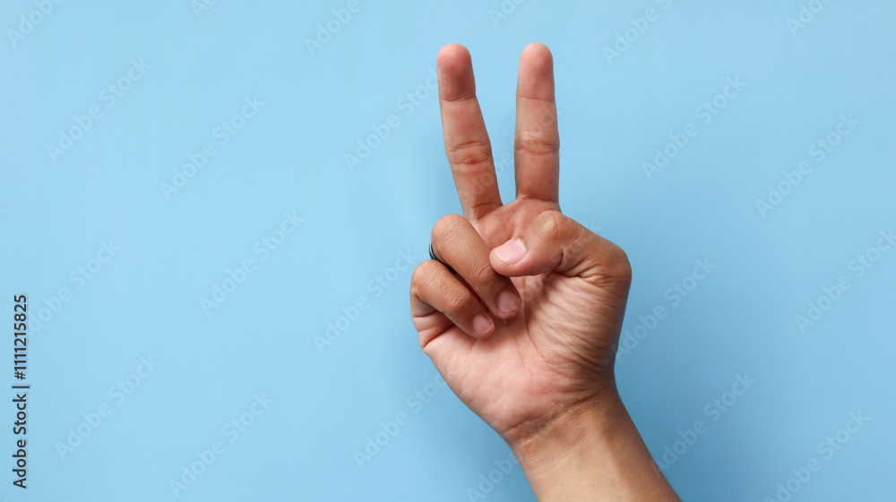 Universal hand gesture of peace. Black hippie shows two fingers, symbol of victory, V sign. Nonverbal communication, body language concept. Universal hand gesture of peace. Black hippie shows two fingers, symbol of victory, V sign. Nonverbal communication, body language concept.