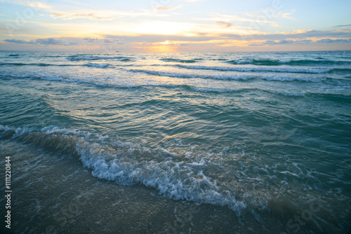 Sunrise on the sea with clouds background. Seascape at evening. Ocean waves background.