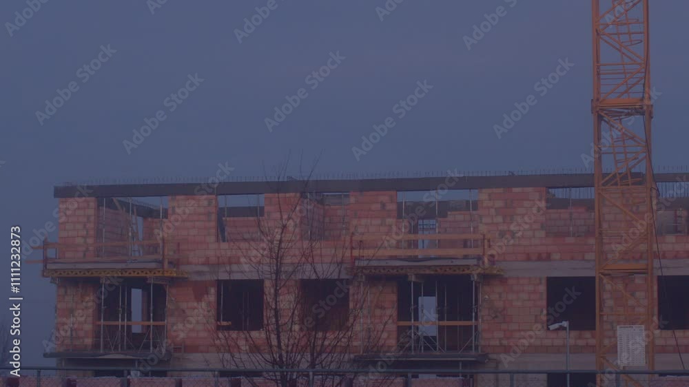 This is a new building construction project that features a sturdy brick structure and temporary scaffold This is a new building construction project that features a sturdy brick structure and temporary scaffold