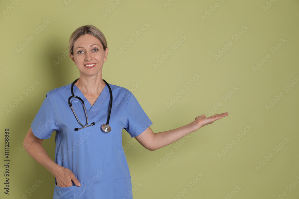 Portrait of nurse in medical uniform with stethoscope on light green background Portrait of nurse in medical uniform with stethoscope on light green background