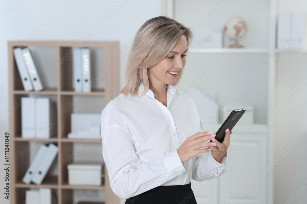 Portrait of businesswoman using smartphone in office Portrait of businesswoman using smartphone in office