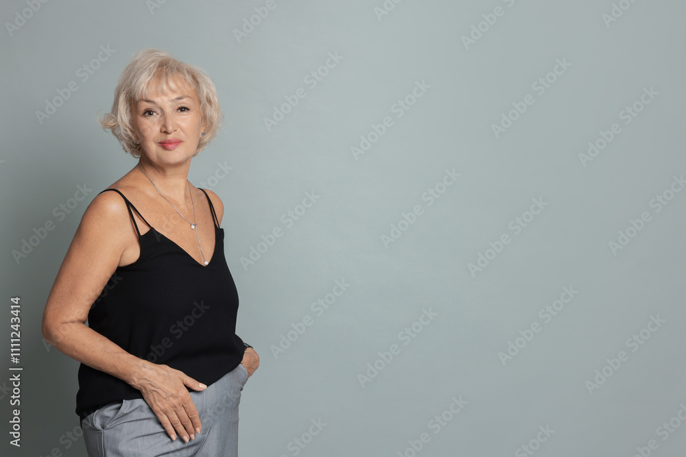 Portrait of beautiful senior woman on light grey background, space for text Portrait of beautiful senior woman on light grey background, space for text