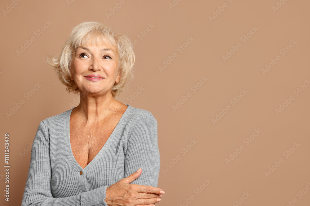 Portrait of beautiful senior woman on light brown background, space for text Portrait of beautiful senior woman on light brown background, space for text