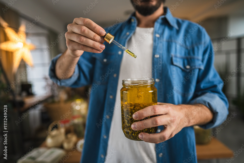 close up of man herbalist prepare natural oils in a rustic workshop close up of man herbalist prepare natural oils in a rustic workshop