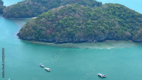 Boats sailing in turquoise waters near a lush coastline, Ang Thong National Park, Thailand