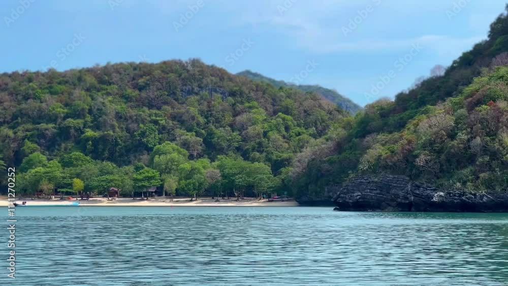 Serene beach view of a lush island with great rock in Thailand Serene beach view of a lush island with great rock in Thailand