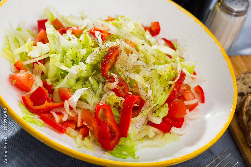 Salad with red bell peppers, lettuce and onions Salad with red bell peppers, lettuce and onions