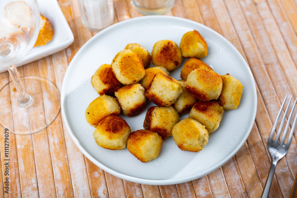 Traditional Spanish tapas caprichos de queso, small savory croquettes with crunchy deep-fried coating and creamy cheese filling Traditional Spanish tapas caprichos de queso, small savory croquettes with crunchy deep-fried coating and creamy cheese filling