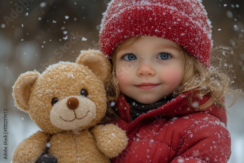 Girl in red jacket and hat holding teddy bear while snow is falling photo