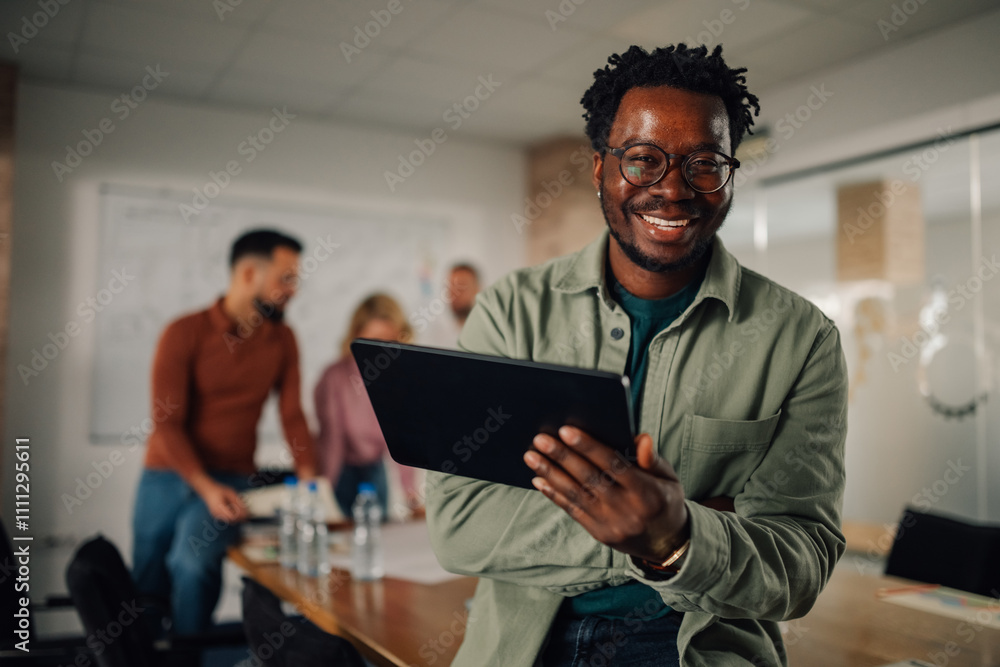 Fototapeta premium Smiling manager using digital tablet during office meeting