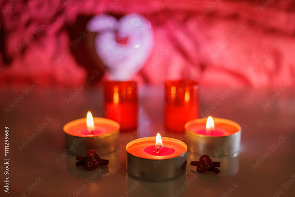 Illuminated tealight candles and red heart Illuminated tealight candles and red heart
