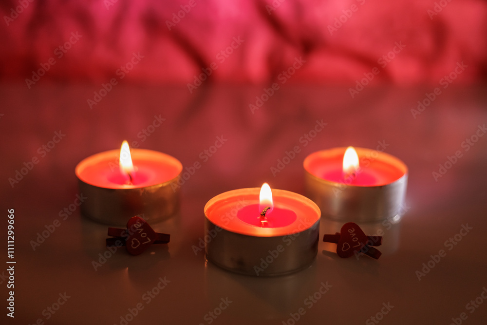 Illuminated tealight candles and red heart Illuminated tealight candles and red heart