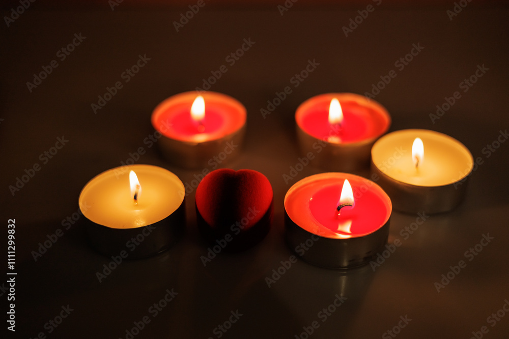 Candles are burning in the dark. Red candles Candles are burning in the dark. Red candles