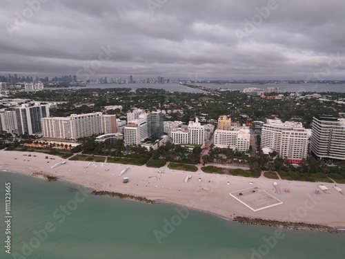 A new day begins with a sunrise over Miami Beach, Florida with white sand and blue waters.