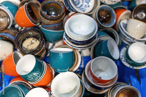 Tableau sur toile A Vibrant Collection of Colorful Ceramic Cups Stacked Together
