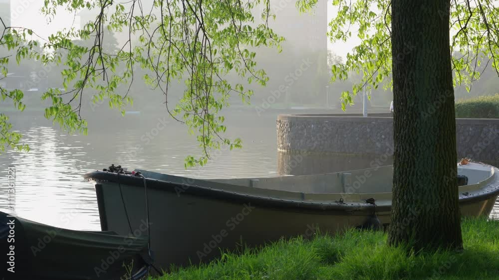 Sundown views of a tranquil canal with lush grass and a boat Sundown views of a tranquil canal with lush grass and a boat