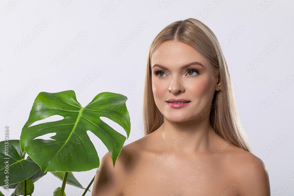 An Elegant Model Posing with a Monstera Leaf in a Beautiful Minimalist Setting that Calms An Elegant Model Posing with a Monstera Leaf in a Beautiful Minimalist Setting that Calms