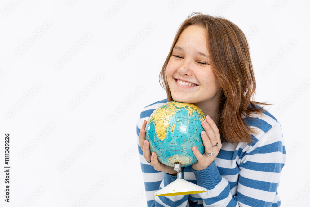 A Happy Smiling Girl is Enthusiastically Holding a Globe, Dressed in a Blue Striped Sweater A Happy Smiling Girl is Enthusiastically Holding a Globe, Dressed in a Blue Striped Sweater