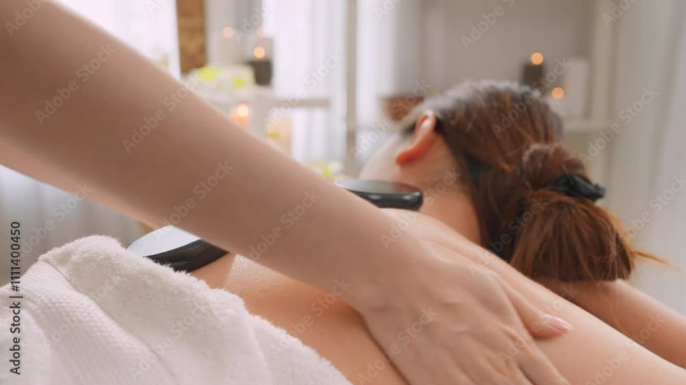 Asian young relaxing woman getting back massage therapy with hot stone. Asian young relaxing woman getting back massage therapy with hot stone.