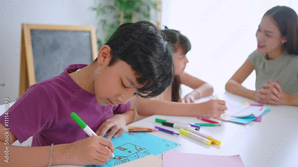 Asian teacher educating students in an art class at elementary school. Asian teacher educating students in an art class at elementary school.