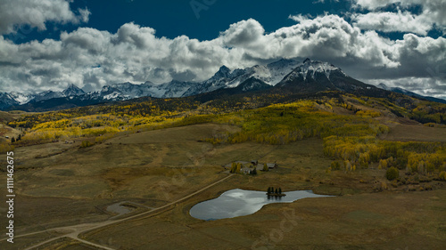 OCT 11, 2023, RIDGWAY, CO., USA - autumn aspen view of San Juan Mountains towards Mnt. Sneffels on Dallas Divide - features Last Dollar Ranch and pond photo