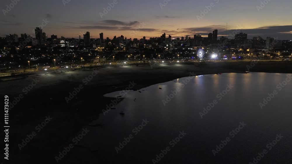 Drone flies to the right over the bay in front of historic city center at night in Asuncion, Paraguay Drone flies to the right over the bay in front of historic city center at night in Asuncion, Paraguay