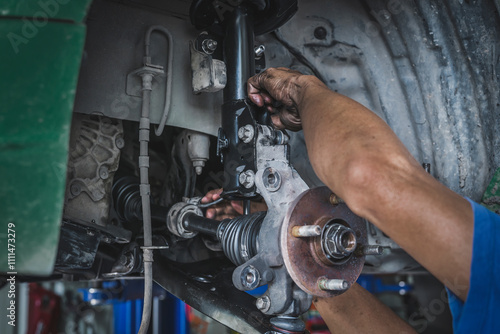 Auto mechanic installing a shock absorber struts ,car suspension repair and service.	