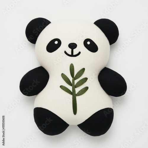 Adorable plush panda toy holding a leaf, isolated on white background. photo