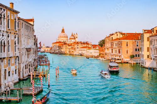 Obraz na płótnie June 25, 2019. Venice, Italy. Beautiful view of traditional Gondola on famous Canal Grande with Basilica di Santa Maria della Salute in golden evening light at sunset in Venice, Italy. w salonie