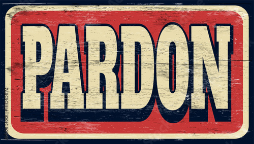 Aged and worn pardon sign on wood