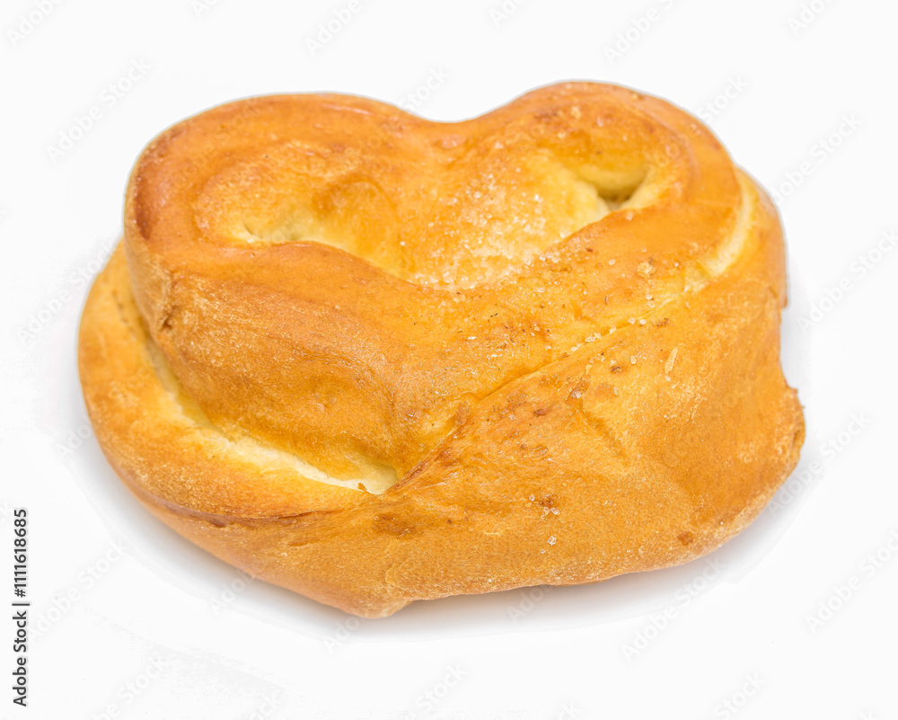 A small, round, yellow pastry with a heart shape on top A small, round, yellow pastry with a heart shape on top