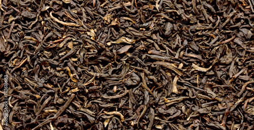 A close up of a pile of black tea leaves