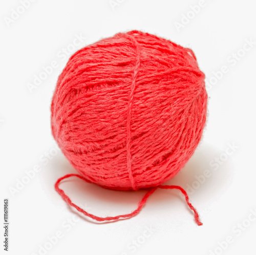 A red ball of yarn is sitting on a white background