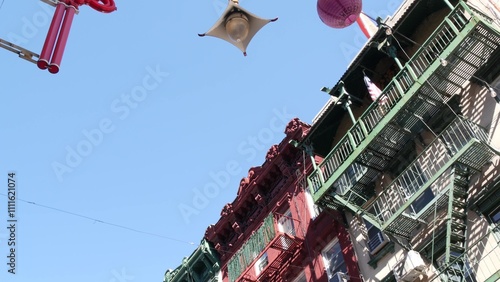 New York City, United States. Manhattan Chinatown Mott street, chinese ethnic district buildings architecture, USA. American red brick house in little China. Fire escape ladder in NYC. Paper lanterns. photo