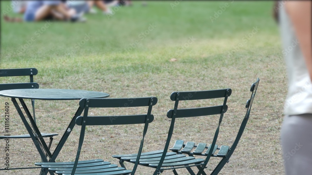 New York City, Manhattan Midtown Bryant Park with Public library, 42 street and 5th Fifth 5 avenue corner, United States. NYC landmark in USA. Chair and table in summer greenery. People on grass lawn. New York City, Manhattan Midtown Bryant Park with Public library, 42 street and 5th Fifth 5 avenue corner, United States. NYC landmark in USA. Chair and table in summer greenery. People on grass lawn.