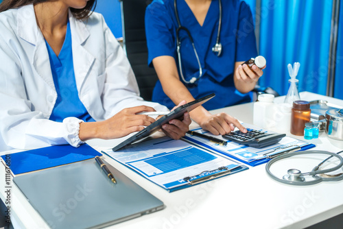 A close-up of two doctors discussing a bottle of medicine at a table in a hospital. They collaborate on patient treatment, analyzing medicine, planning care, and using advanced technology