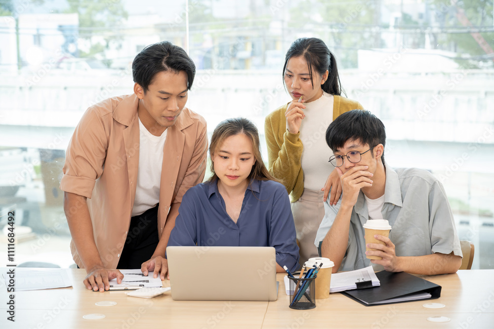 An Asian business startup team brainstorming, sharing creative and helpful ideas, and discussing a project in a modern office. A senior female boss works with young employees in the office. An Asian business startup team brainstorming, sharing creative and helpful ideas, and discussing a project in a modern office. A senior female boss works with young employees in the office.