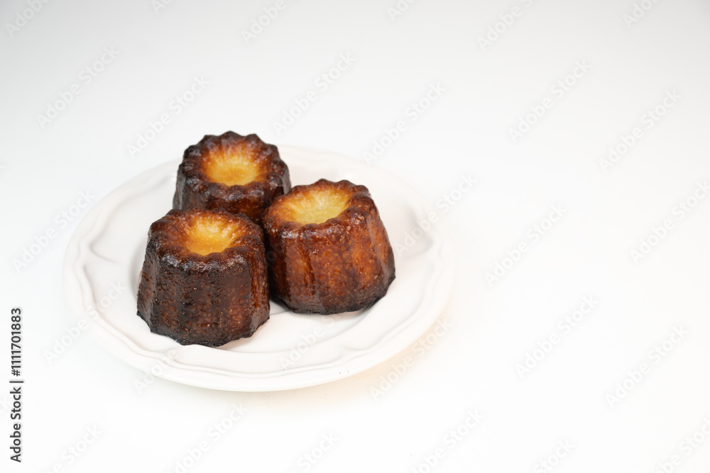Caneles de bordeaux, traditional French sweet dessert with white table background, High quality photo Caneles de bordeaux, traditional French sweet dessert with white table background, High quality photo