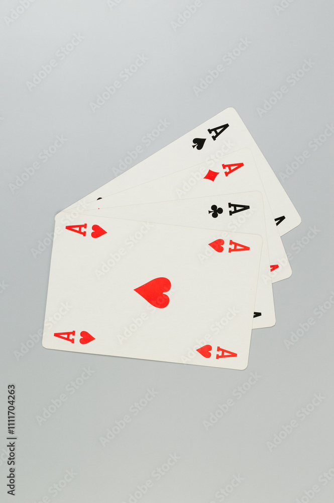 Top view of playing cards on grey background. Four aces cards, board game, poker. Copy space, flat lay. Top view of playing cards on grey background. Four aces cards, board game, poker. Copy space, flat lay.