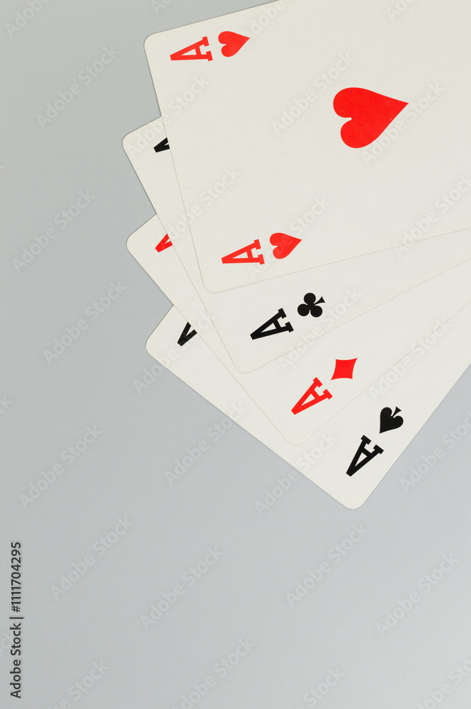 Obraz premium Top view of playing cards on grey background. Four aces cards, board game, poker. Copy space, flat lay.