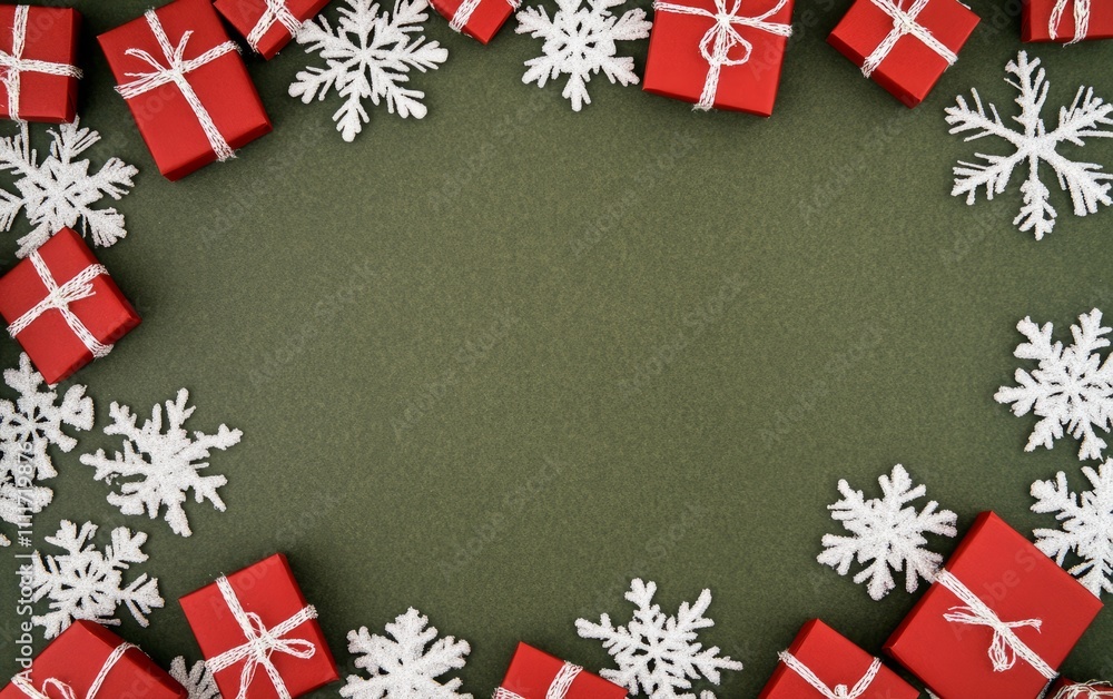 Red Christmas presents on an olive green background with lots of white space Red Christmas presents on an olive green background with lots of white space