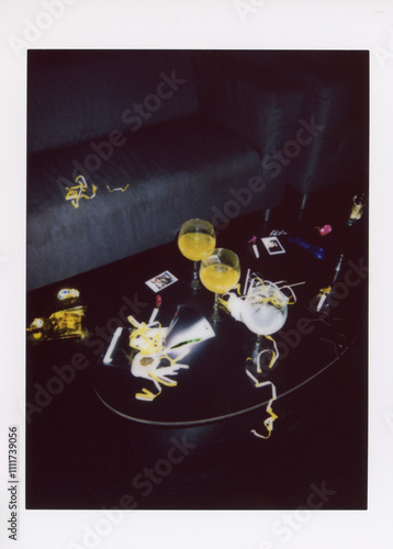 Photography A classic instant camera photo capturing the aftermath of a party with drinks and decorations