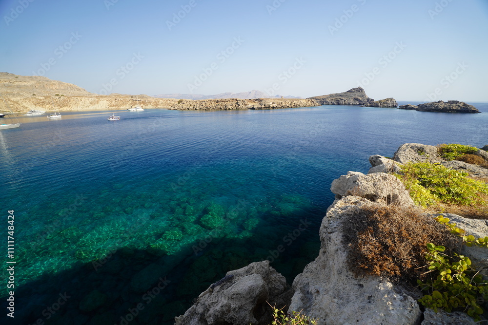 rocky cliffs of Lindos , coastline around the Acropolis with turquoise water rocky cliffs of Lindos , coastline around the Acropolis with turquoise water