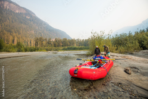 Two men prepare their raft for a day on the river photo