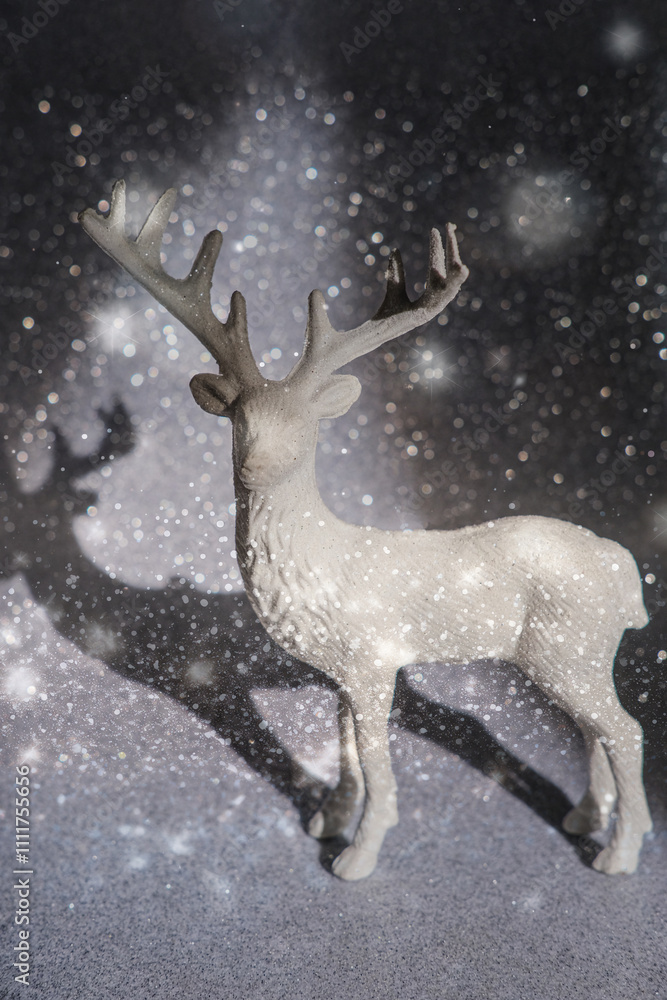Deer figurine on a glittery snowy background Deer figurine on a glittery snowy background