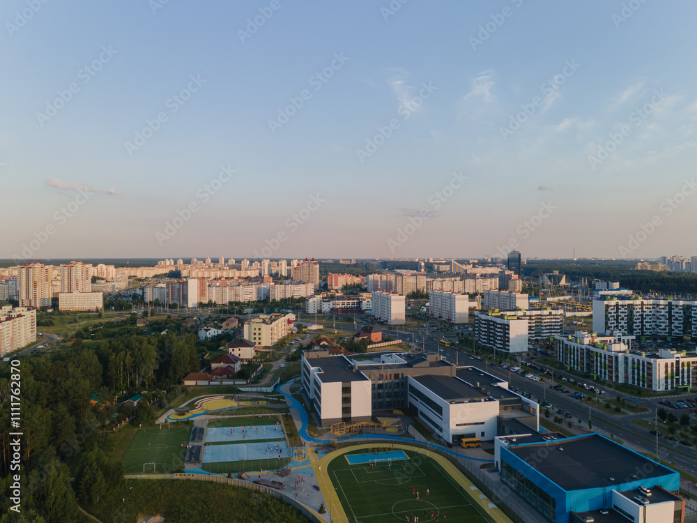 Obraz premium Top view of the city, landscape and buildings, sky and silhouettes of houses from the height of a flying drone. 