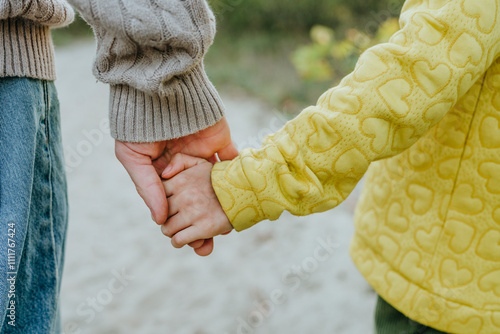 Father holding hands with daughter photo