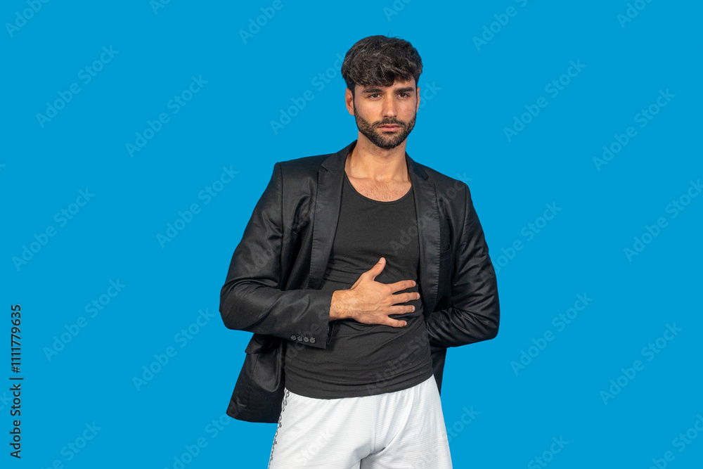 Fashionable man posing in studio, showcasing modern style with a confident expression Fashionable man posing in studio, showcasing modern style with a confident expression