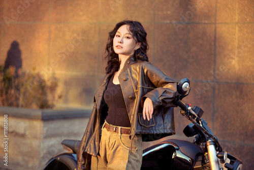 Oriental beauty taking photos on a retro motorcycle at sunset